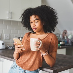 drinking coffee and using smartphone