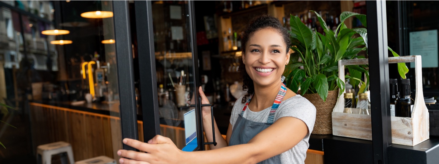 smiling woman opening door